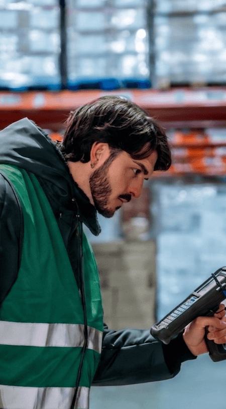 Alltrans - Warehouse worker scanning- (1) Worker scanning barcode on frozen goods in logistics warehouse