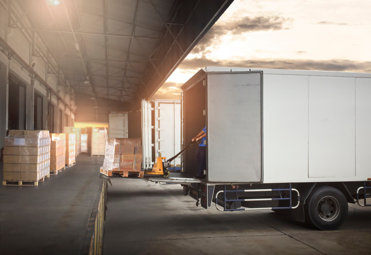 Package Boxes on Pallets Loading into Cargo Truck Container