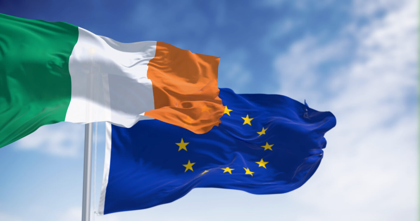 Flags of Ireland and the European Union waving on a clear day